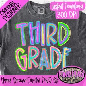 May include: A charcoal gray t-shirt featuring the text THIRD GRADE in a multi-colored, hand-drawn style with neon pink, orange, yellow, green, and blue outlines. The shirt has a crew neckline and a label reading Comfort Colors.