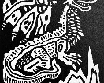 May include: Black and white linocut print of a dragon with a long, curled tail and a jagged, spiky body. The dragon is standing on a series of wavy lines, which represent water.