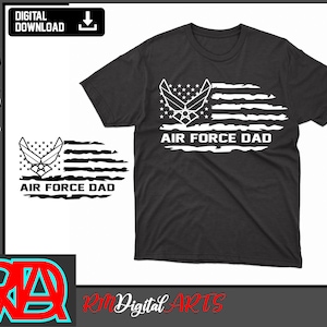 May include: A black t-shirt featuring a white distressed American flag design with the words "Air Force Dad" in white text. The flag design incorporates the Air Force emblem.