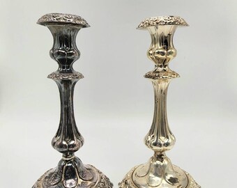 May include: Two silver candle holders with ornate designs. The candle holder on the left is tarnished, while the candle holder on the right is polished.
