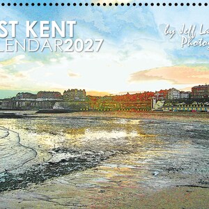 May include: A 2027 wall calendar featuring a coastal landscape of East Kent with a sandy beach, tide pools, and buildings along the cliffside at sunset. The text reads EAST KENT CALENDAR 2027 by Jeff Laurents Photography in white lettering.