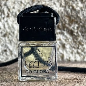 May include: A clear, rectangular car air freshener with a black cap and a black cord. The label reads "Car Perfume" and "HECTORS GO GLOBAL". The car air freshener is filled with a clear liquid.