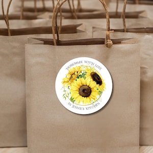 May include: Brown paper gift bags with a round sticker featuring a watercolor illustration of sunflowers and the text "Homemade with love in Jennie's Kitchen".