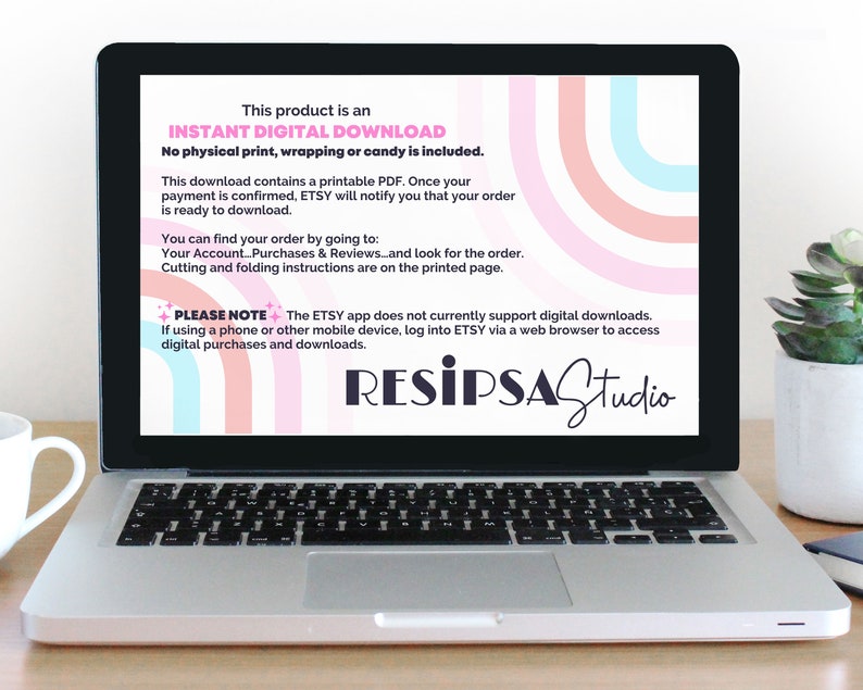 May include: A laptop screen displaying a pink, blue, and white graphic design with the text "This product is an INSTANT DIGITAL DOWNLOAD. No physical print, wrapping or candy is included." and "PLEASE NOTE+ The ETSY app does not currently support digital downloads. If using a phone or other mobile device, log into ETSY via a web browser to access digital purchases and downloads." The text "RESIPSAStudio" is in black and white.