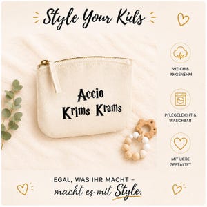 Könnte beinhalten: Eine cremefarbene Reißverschlusstasche mit dem Text "Accio Krims Krams" in Schwarz. Ein Beißring aus Holz und weißen Perlen befindet sich neben der Tasche. Der Text "Style Your Kids" steht oben im Bild.
