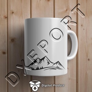 May include: White ceramic mug with a black silhouette of a mountain range with trees on a white background.  The mug is on a wood background.