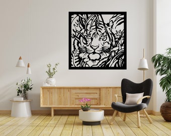 May include: Black and white laser-cut wall art featuring a tiger's face amidst foliage. The artwork is framed in a black square and is displayed above a wooden cabinet in a modern living room setting.