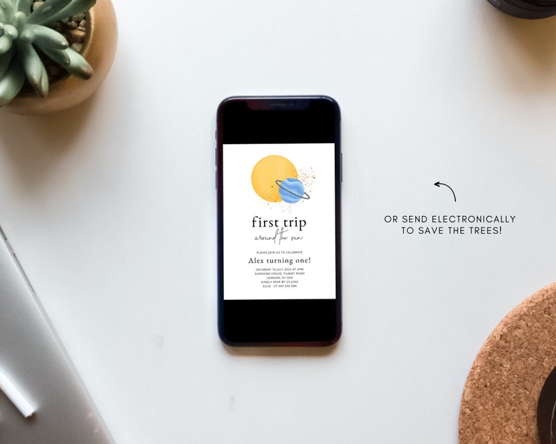 May include: A digital invitation for a first birthday party with a space theme. The invitation features a yellow sun with a blue planet and a ring around it. The text on the invitation reads "first trip around the sun" and "Alex turning one!"