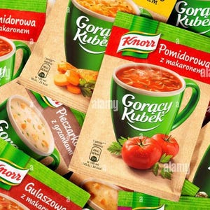 May include: An assortment of Knorr instant soup packets featuring images of tomato soup, mushroom soup, and goulash soup. The packets are primarily green, red, and tan, with the words "Goracy Kubek" and "Knorr" prominently displayed.