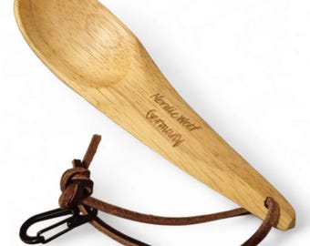 May include: A wooden spoon with a leather strap and a carabiner clip. The spoon is engraved with "Nordic Wood Germany".