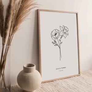 Witte poster met houten lijst. Poster met geboorte bloem boeket lijn tekening zwart wit met tekst. Minimalistische stijl.