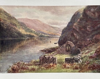 May include: A watercolour painting depicting a stone building with a window, perched on a grassy hill overlooking a lake. The lake is surrounded by hills and trees, and the sky is overcast.