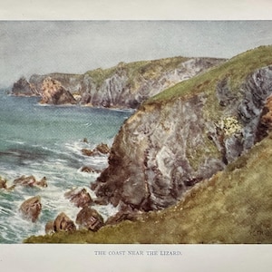 May include: A watercolour painting depicting a coastal scene. The image shows rugged cliffs covered in green vegetation meeting the turquoise sea. The artwork is titled "The Coast Near The Lizard" and has a vintage aesthetic.