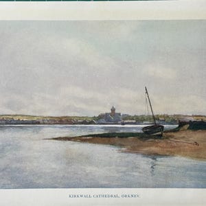 May include: Watercolor painting of Kirkwall Cathedral, Orkney. A small sailboat rests on a sandy shore, with the cathedral and town in the background. The sky is overcast, and the water reflects the muted colors of the scene.
