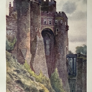 May include: Watercolor painting of The Constable's Tower at Dover Castle. The image depicts a stone castle with multiple towers, arched gateways, and a bridge. The castle is set on a hillside with green foliage and a cloudy sky.