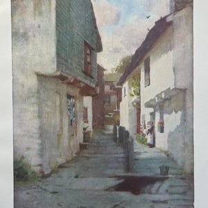 May include: A watercolor painting of a narrow, cobblestone street in a village. The street is lined with whitewashed buildings with green wooden accents. The buildings have a rustic charm and are surrounded by lush greenery. The painting captures the quaint and peaceful atmosphere of a small town.