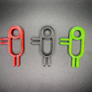 May include: Three stylized figures, each with a different color: red, black, and green. Each figure has a round head with a circle in the center, two arms, and two legs.