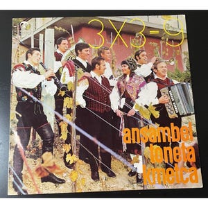 May include: A vintage vinyl record cover featuring a group of musicians in traditional clothing. The cover is orange and white with the text "3x3=9 ansambl toneta kmecka".
