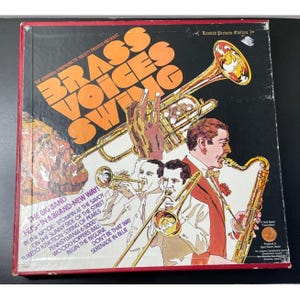 May include: Vintage vinyl record album cover for "Brass Voices Swing" by The Longines Symphonette Society. The cover features illustrations of musicians playing brass instruments, with text in orange and white on a black background.