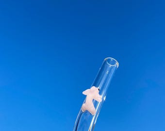 reusable glass straw with a mini glass figurine .