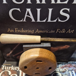 May include: A white ceramic mug with a black handle and the text "But First, Coffee" in a black, bold font. The mug is on a white surface.