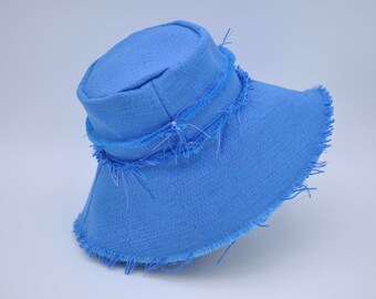 May include: A light blue bucket hat with a frayed edge.