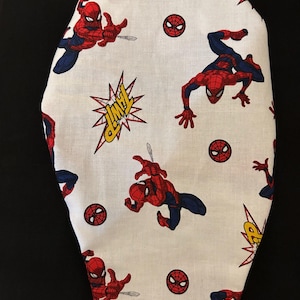 May include: White fabric with a repeating pattern of Spiderman in a red and blue suit, a red spider symbol, and a yellow comic book style "POW!" sound effect.