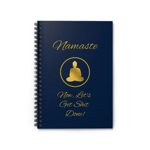 May include: A dark blue spiral notebook with a gold foil design. The cover features a gold silhouette of a meditating Buddha in a circle with the word "Namaste" above it and the text "Now, Let's Get Shit Done!" below it.