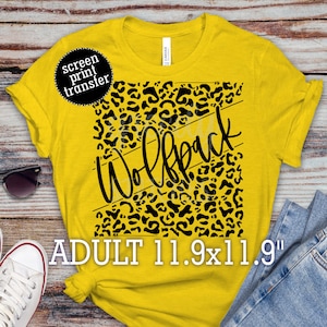 May include: Yellow t-shirt with a black leopard print design and the word "Wolfpack" in black script. The shirt is an adult size and measures 11.9 inches by 11.9 inches.