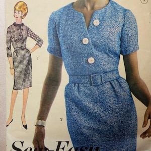 May include: A vintage sewing pattern for a dress with a V-neckline, short sleeves, and a belt. The dress is made of a blue and white patterned fabric. The pattern is labelled "Sew Easy".