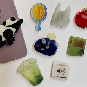 Phone Grips Extravaganza: Lemonade, Cuddly Pandas, Delectable Croissants & More! | Elevate Your Style with Distinctive Designs Universal Fit