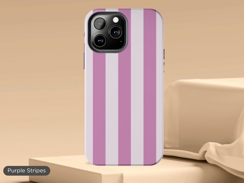 May include: A phone case for an iPhone with purple and white stripes.