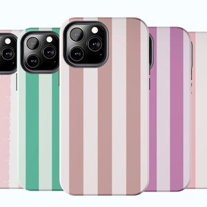 May include: Four phone cases with different striped patterns. The cases are pink, green, brown, and purple with white stripes. The cases are designed for a phone with a triple camera lens.
