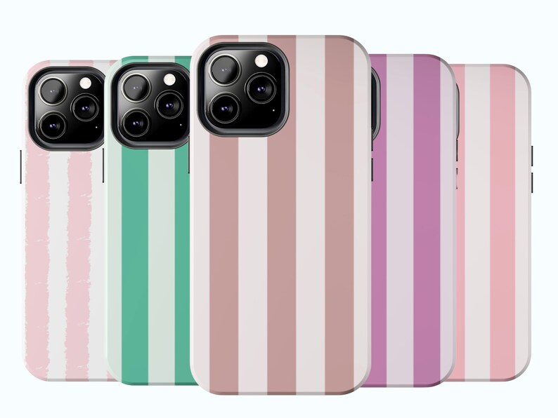 May include: Four phone cases with different striped patterns. The cases are pink, green, brown, and purple with white stripes. The cases are designed for a phone with a triple camera lens.