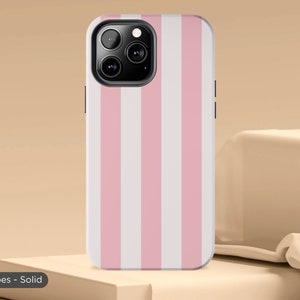 May include: A pink and white striped phone case for an iPhone. The case has a solid colour design with vertical stripes.