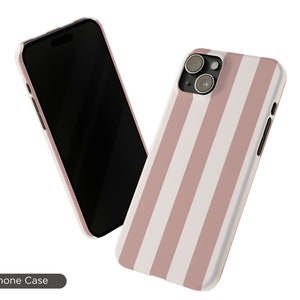 May include: A pink and white striped phone case with a camera cutout. The case is designed to fit a smartphone with a triple lens camera system.