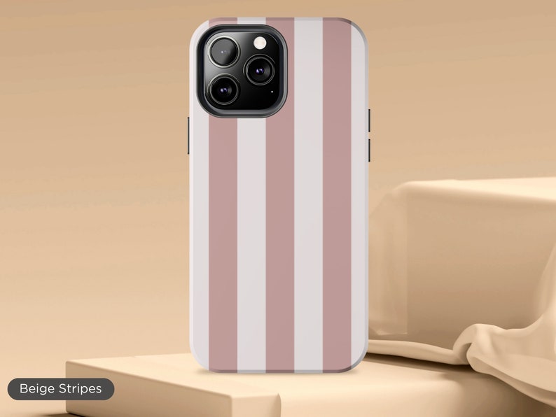 May include: A pink and white striped phone case for an iPhone. The case has a camera cutout and a beige stripe pattern.