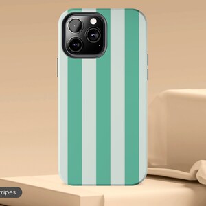May include: A green and white striped phone case for an iPhone. The case has a camera cutout and a raised lip around the edges.
