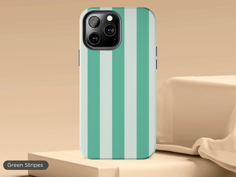 May include: A green and white striped phone case for an iPhone. The case has a camera cutout and a raised lip around the edges.