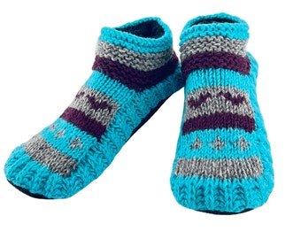 May include: A pair of blue, grey, and purple knitted slipper socks. The socks have a striped pattern and are made of soft, warm wool.
