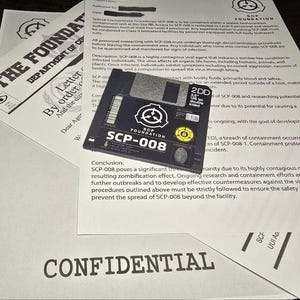 May include: A black 3.5-inch floppy disk labelled SCP-008 with the SCP Foundation logo, resting on white paper documents. The documents feature the text THE FOUNDATION, DEPARTMENT OF CONTAINMENT, and CONFIDENTIAL, detailing containment protocols for a viral agent.