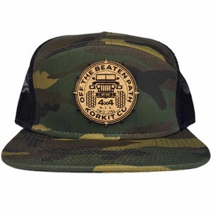 May include: A camouflage trucker hat with a cork patch that says "Off the Beaten Path" with a jeep silhouette and "4x4 Korkit Co."