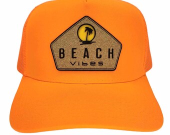 May include: Orange trucker hat with a cork patch that says "BEACH vibes" and a silhouette of a palm tree and sun.
