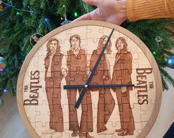 May include: A wooden clock with a jigsaw puzzle design featuring a photo of The Beatles. The clock has black hands and a white background. The Beatles are pictured in black and white.