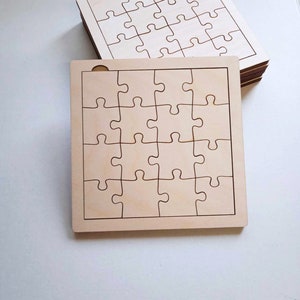 May include: Two unfinished wooden jigsaw puzzles with a 5x5 grid of puzzle pieces. The puzzles are made of light brown wood and have a smooth surface.