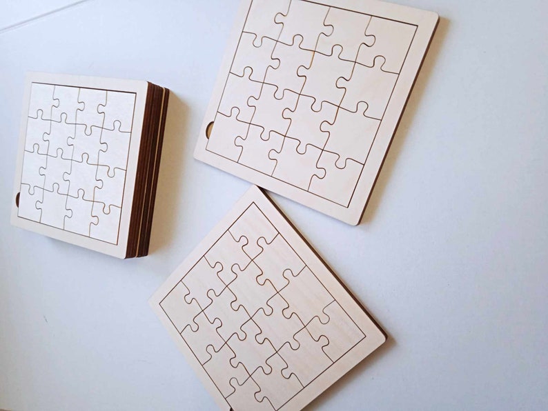May include: Three unfinished wooden jigsaw puzzles, each with 16 pieces. The puzzles are square shaped and have a light wood colour.