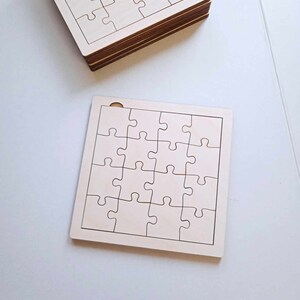 May include: Two unfinished wooden jigsaw puzzles, each with 25 pieces. The puzzles are blank and ready to be painted or decorated.