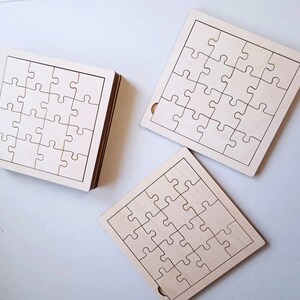 May include: Three unfinished wooden jigsaw puzzles, each with 25 pieces. The puzzles are square shaped and have a white background with black lines outlining the puzzle pieces.