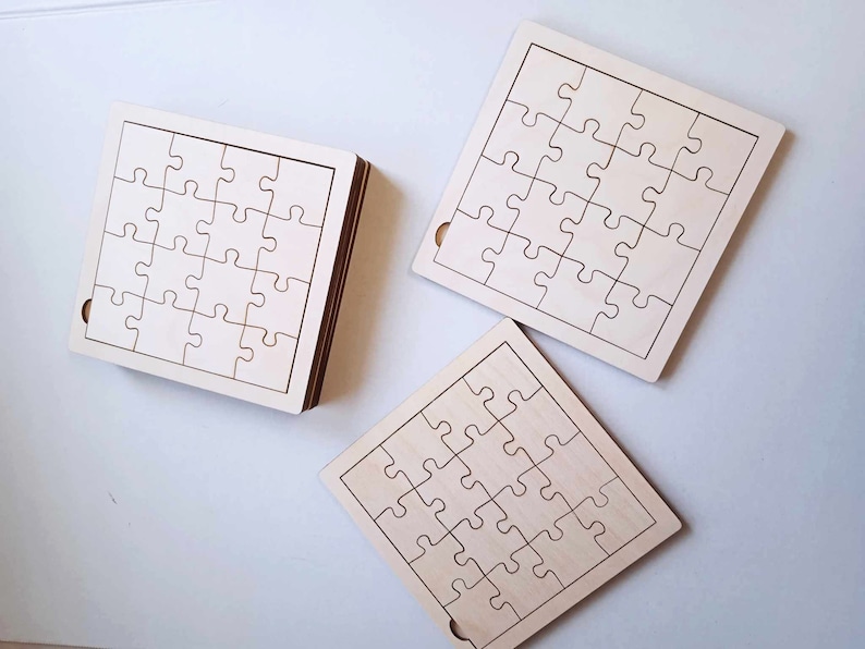 May include: Three unfinished wooden jigsaw puzzles, each with 25 pieces. The puzzles are square shaped and have a white background with black lines outlining the puzzle pieces.