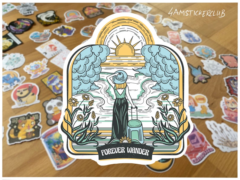 May include: A die-cut sticker featuring a person in a hat and long dress standing with a suitcase, facing a sunrise over the ocean. The scene is framed by clouds and flowers, with the text FOREVER WANDER printed in a black banner at the bottom.